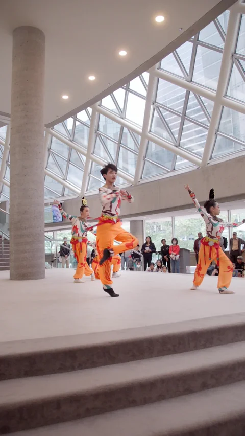 Dancers welcoming families in the concert hall lobby