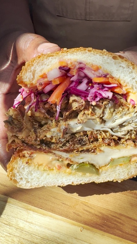 A closeup of a freshly cut Rily sandwich